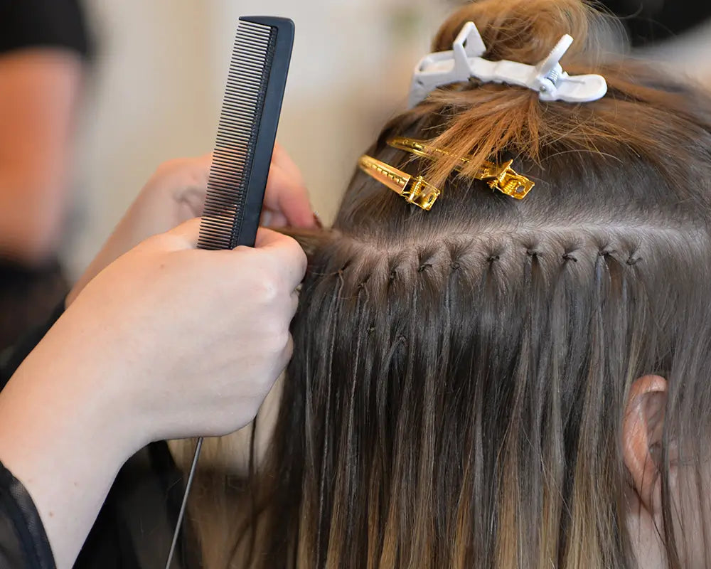 Mago certified stylist installing hair extensions